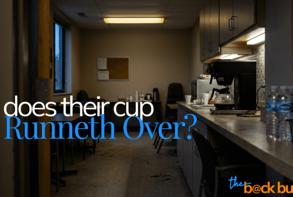 a photograph of an office break room with a nearly empty coffee pot on the counter. The break room looks shabby and unattractive, highlighting that the team is at capacity.