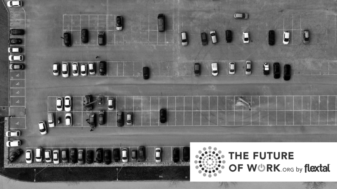 black and white image of a parking lot from above - most of the parking spaces are available
